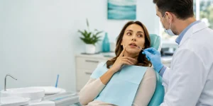 Patient discussing tooth pain during a large filling replacement assessment.