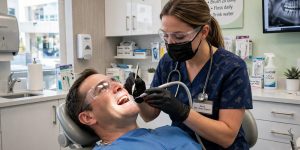 Dental hygienist professionally cleaning a patient's teeth in Newmarket